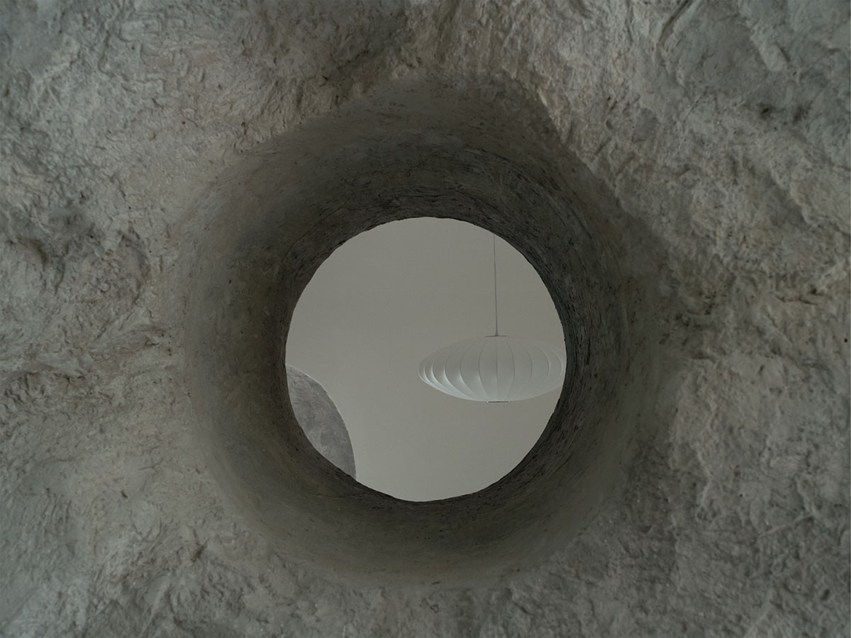 B.L.U.E. Architecture Studio adds a glazed cafe by using organic forms of stones to an open plaza