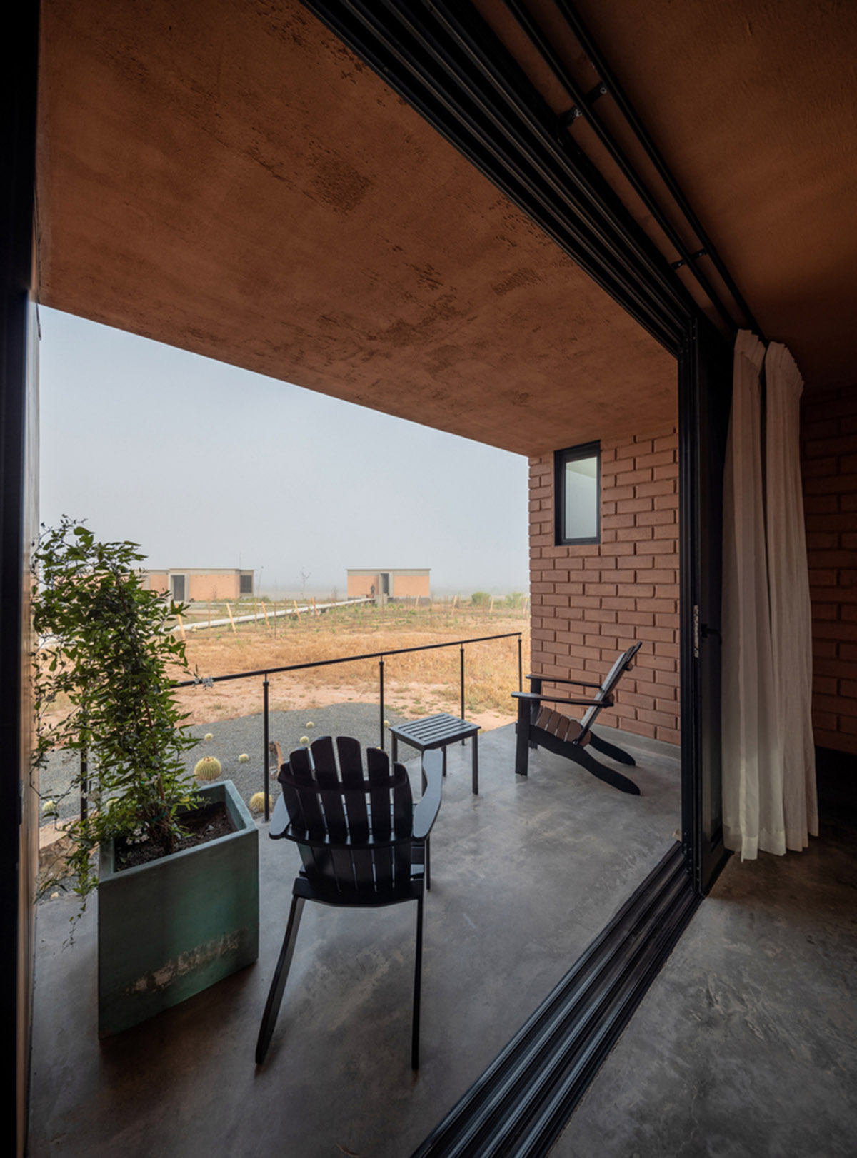 Santos Bolívar's rammed-earth hotel blocks are raised on inclined mirror bases in Mexican landscape