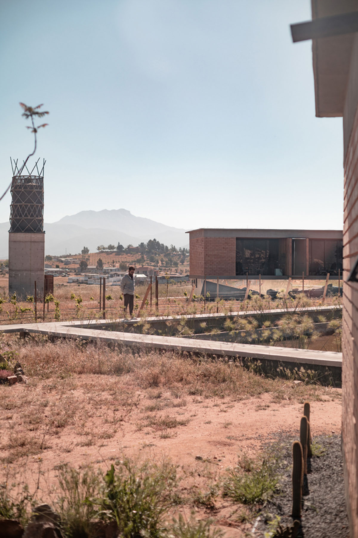 Santos Bolívar's rammed-earth hotel blocks are raised on inclined mirror bases in Mexican landscape