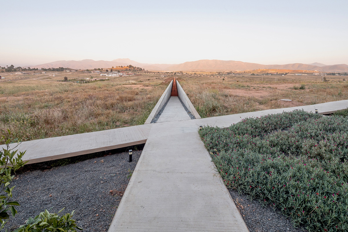 Santos Bolívar's rammed-earth hotel blocks are raised on inclined mirror bases in Mexican landscape