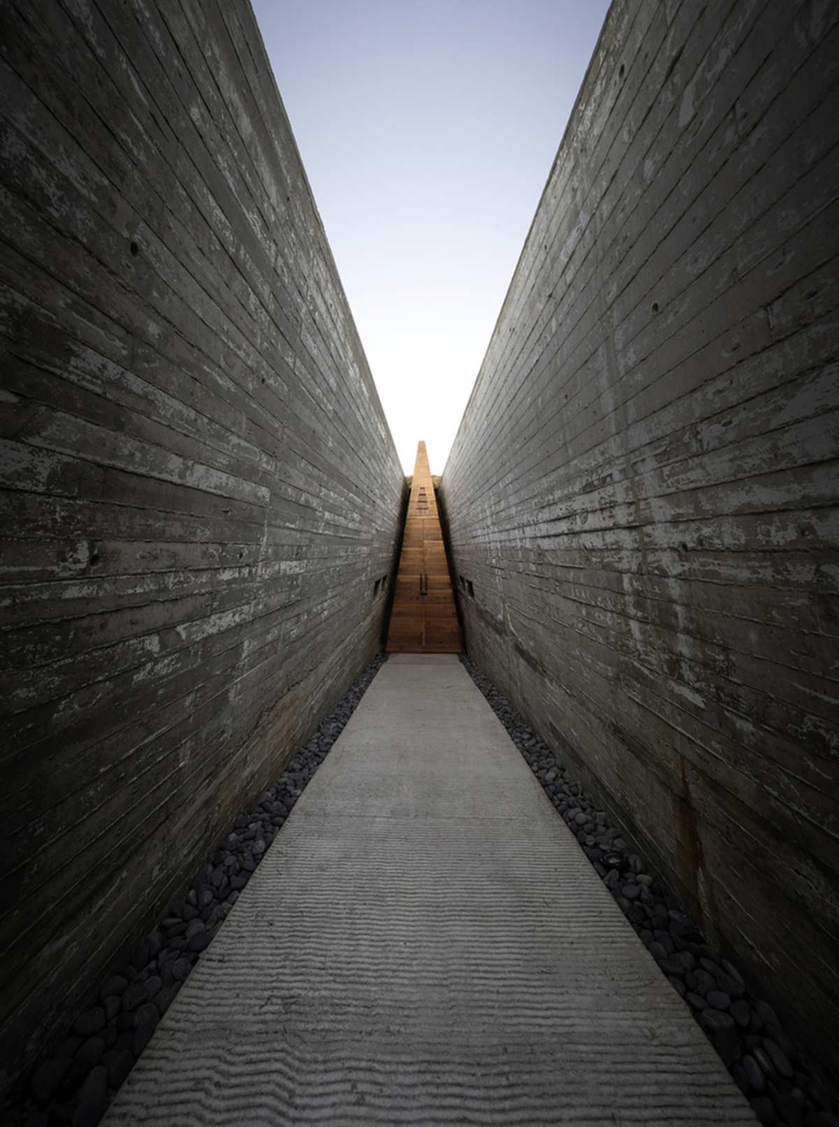 Santos Bolívar's rammed-earth hotel blocks are raised on inclined mirror bases in Mexican landscape