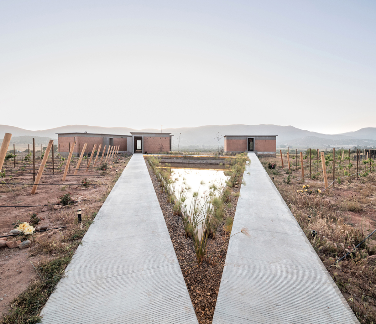 Santos Bolívar's rammed-earth hotel blocks are raised on inclined mirror bases in Mexican landscape