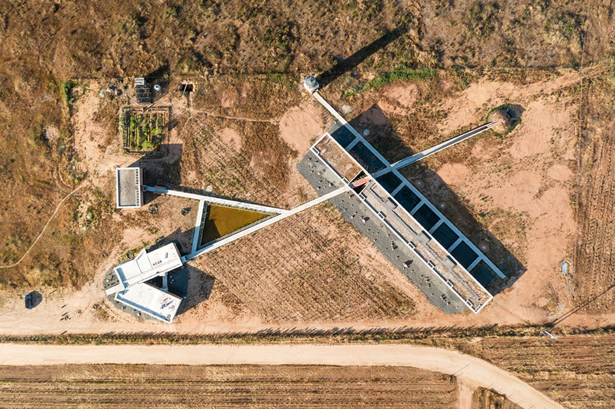 Santos Bolívar's rammed-earth hotel blocks are raised on inclined mirror bases in Mexican landscape