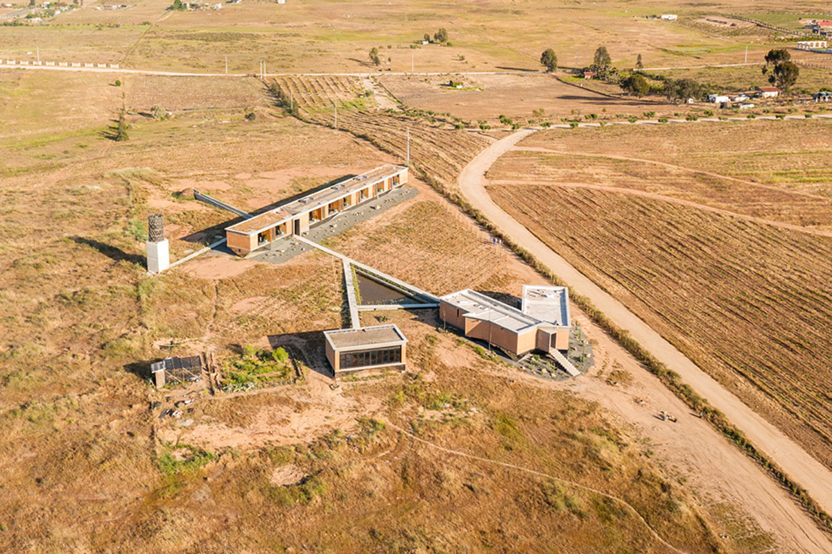 Santos Bolívar's rammed-earth hotel blocks are raised on inclined mirror bases in Mexican landscape