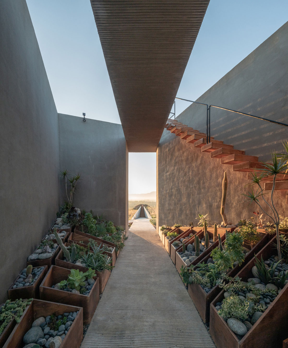 Santos Bolívar's rammed-earth hotel blocks are raised on inclined mirror bases in Mexican landscape
