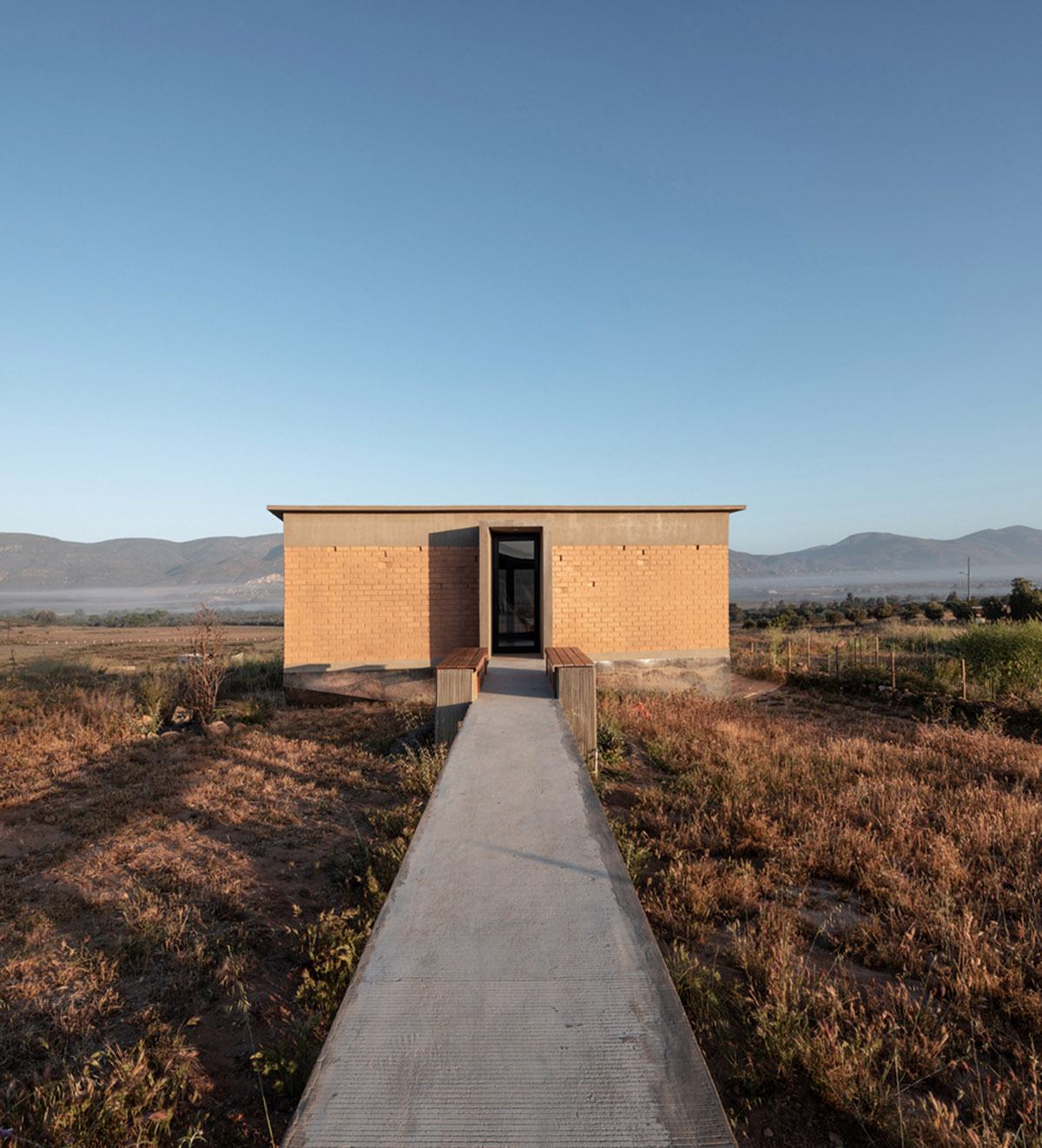 Santos Bolívar's rammed-earth hotel blocks are raised on inclined mirror bases in Mexican landscape