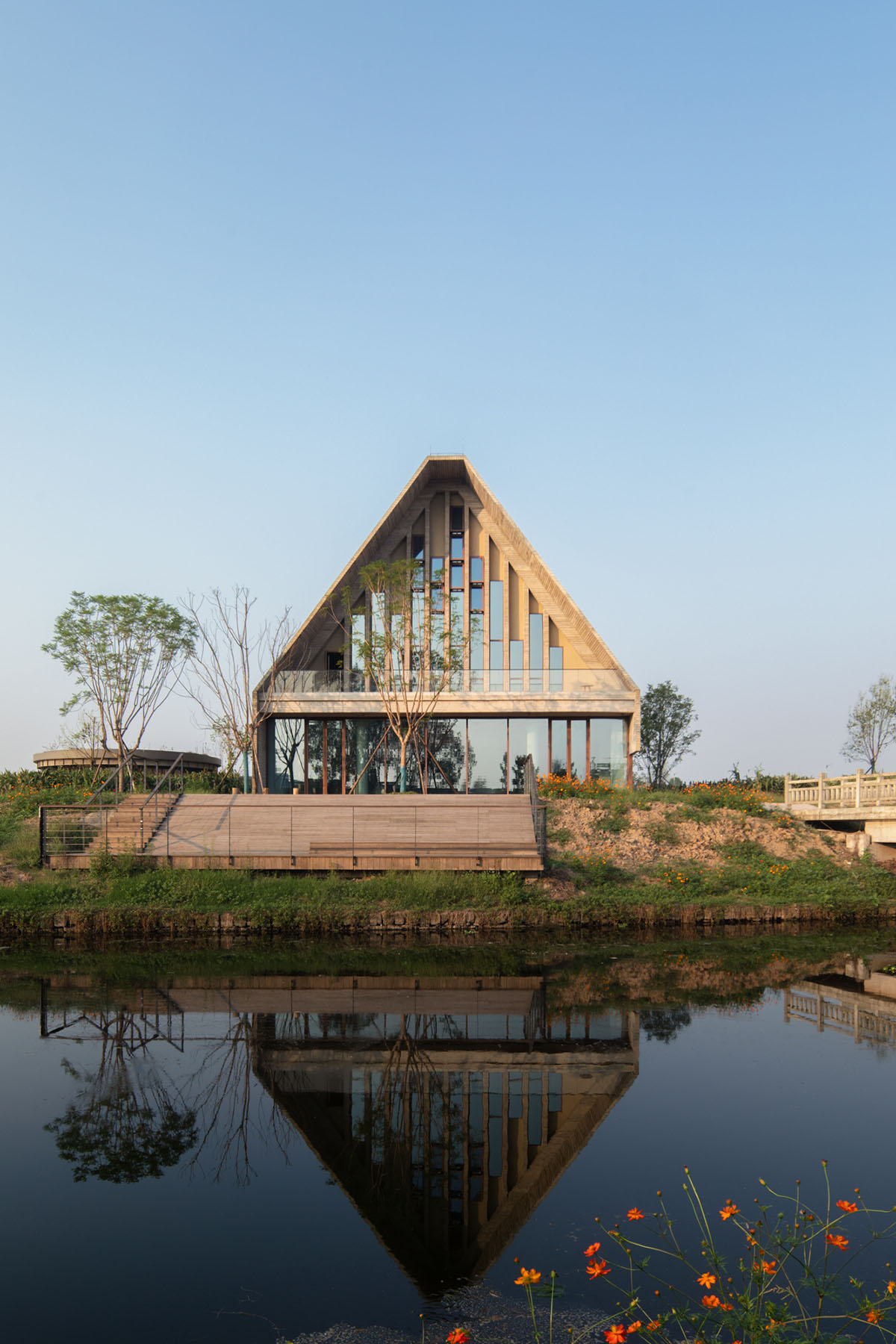 Concrete Land Museum made of pitched roof overlooks sorghum fields on Island Hopping Village