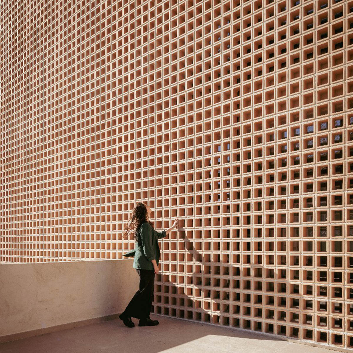 Casa Umbral features a brick-lattice façade that scatters soft light into the interior in Madrid