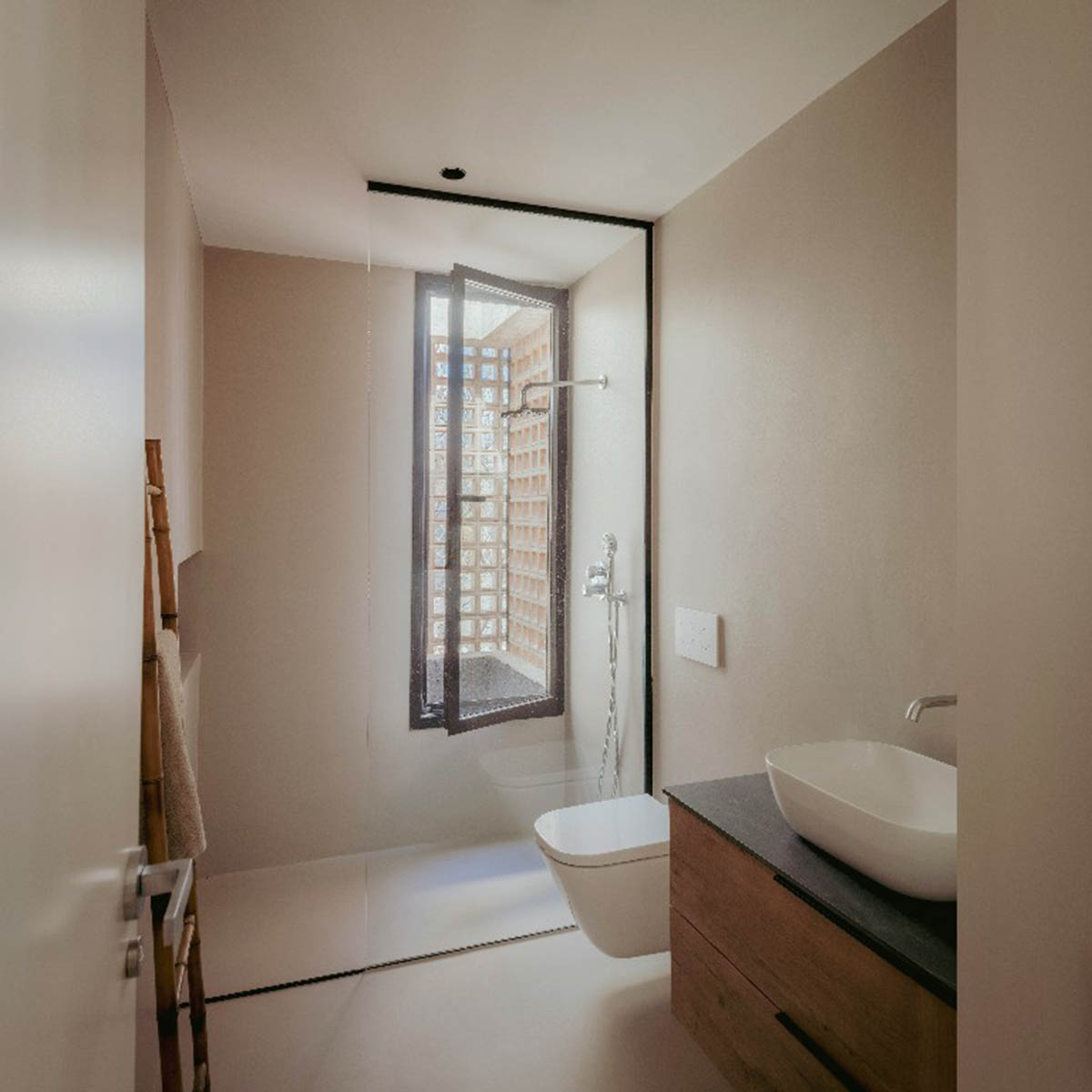 Casa Umbral features a brick-lattice façade that scatters soft light into the interior in Madrid