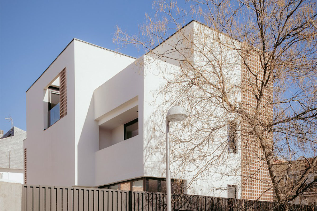 Casa Umbral features a brick-lattice façade that scatters soft light into the interior in Madrid