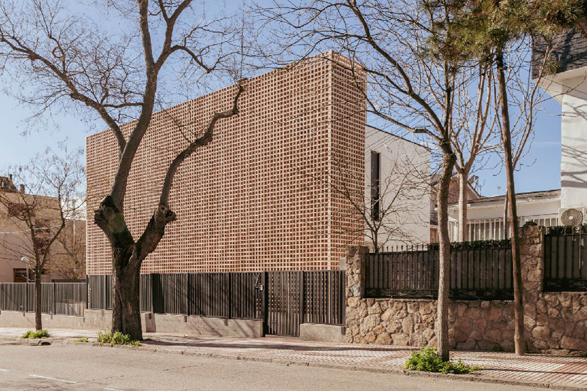 Casa Umbral features a brick-lattice façade that scatters soft light into the interior in Madrid