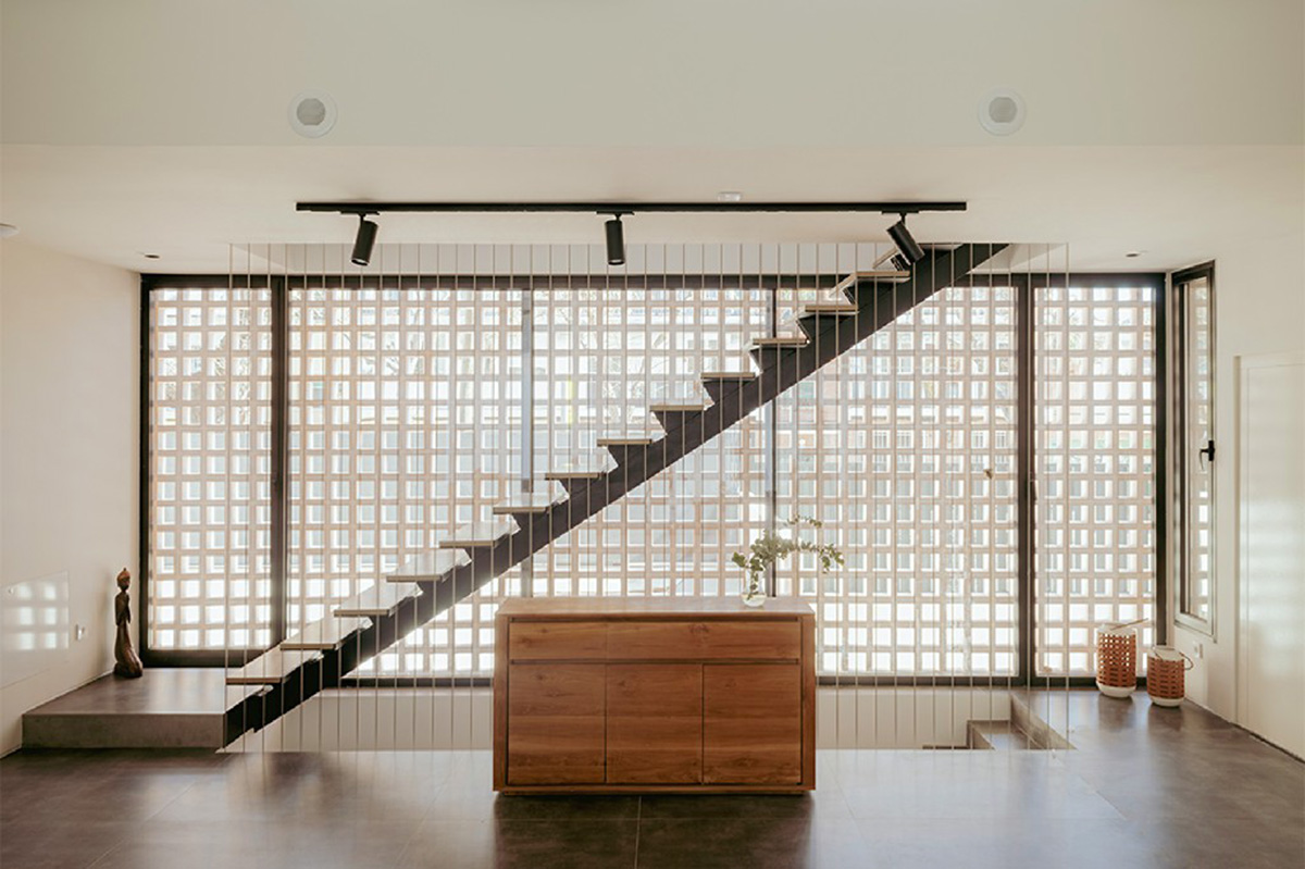 Casa Umbral features a brick-lattice façade that scatters soft light into the interior in Madrid