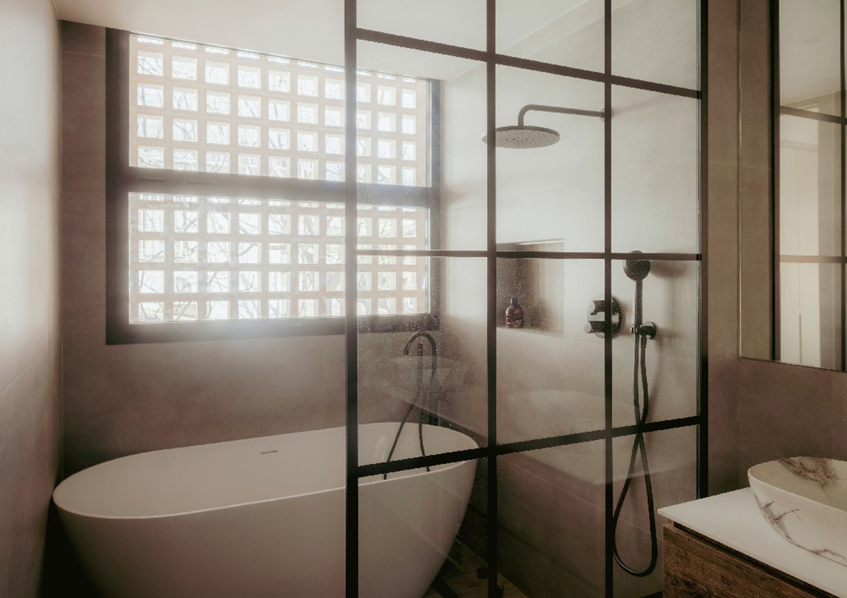 Casa Umbral features a brick-lattice façade that scatters soft light into the interior in Madrid