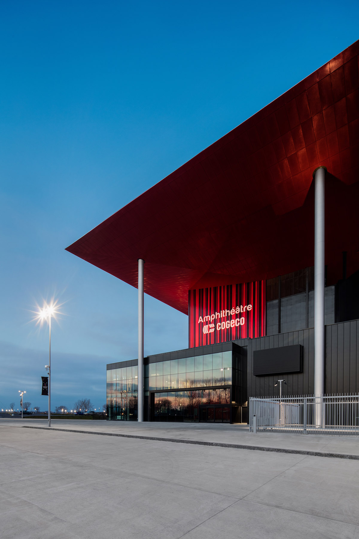 Paul Laurendeau completes outdoor summer amphitheater in Quebec with bold red floating roof