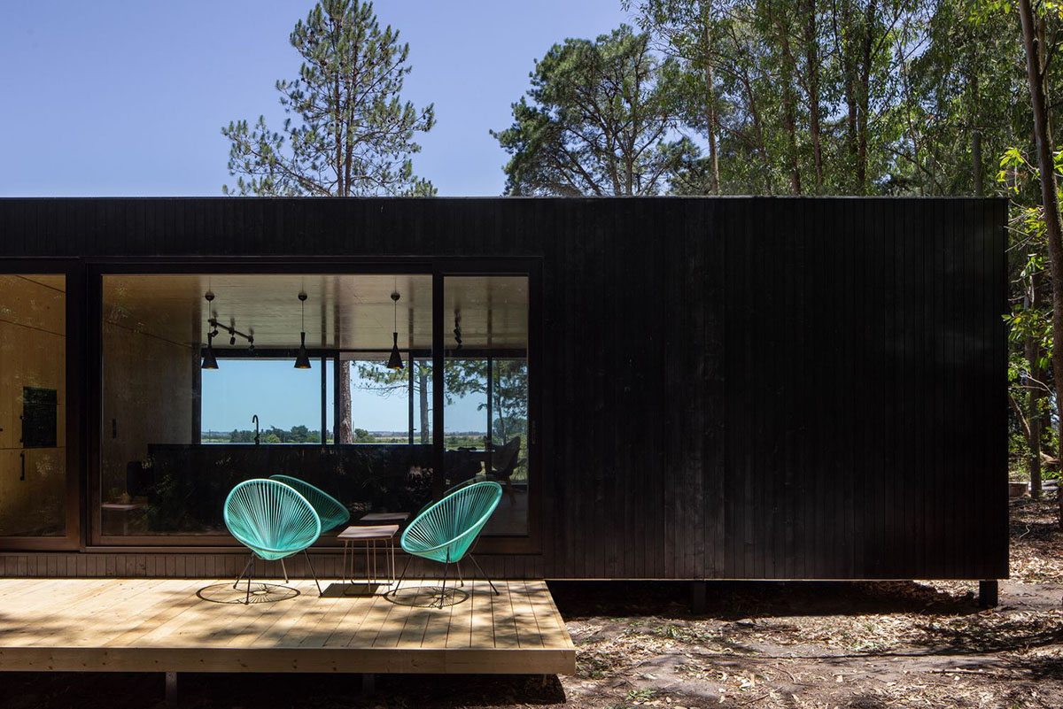 Black wooden cabin by iHouse estudio is an off-grid escape home in Uruguayan native forest