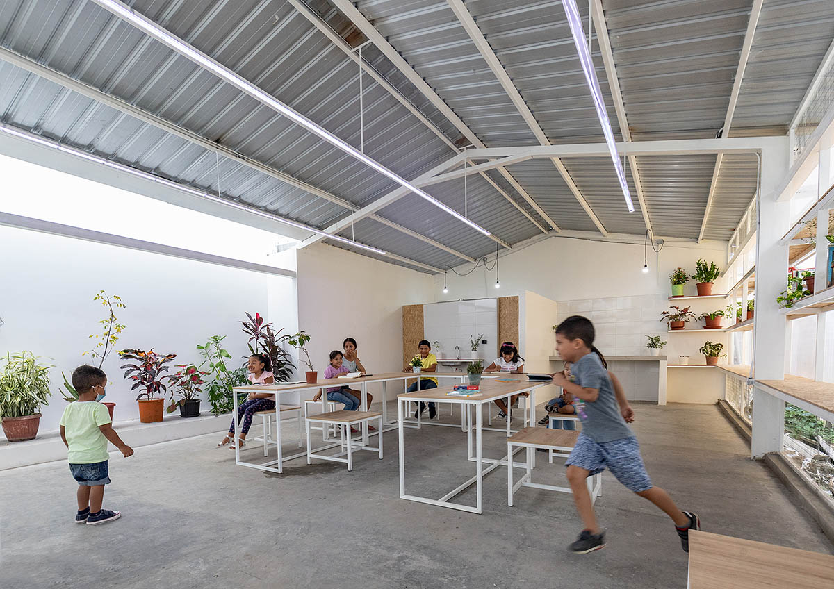 Permeable community house is inserted into Ecuador's existing fabric to serve micro communities 