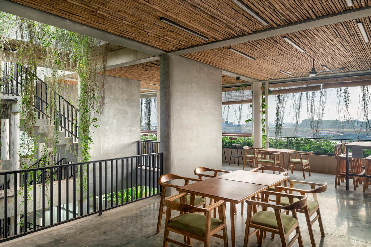 T3 Architects covers façade of Coconut Club in Cambodia with natural curtain made of plants 