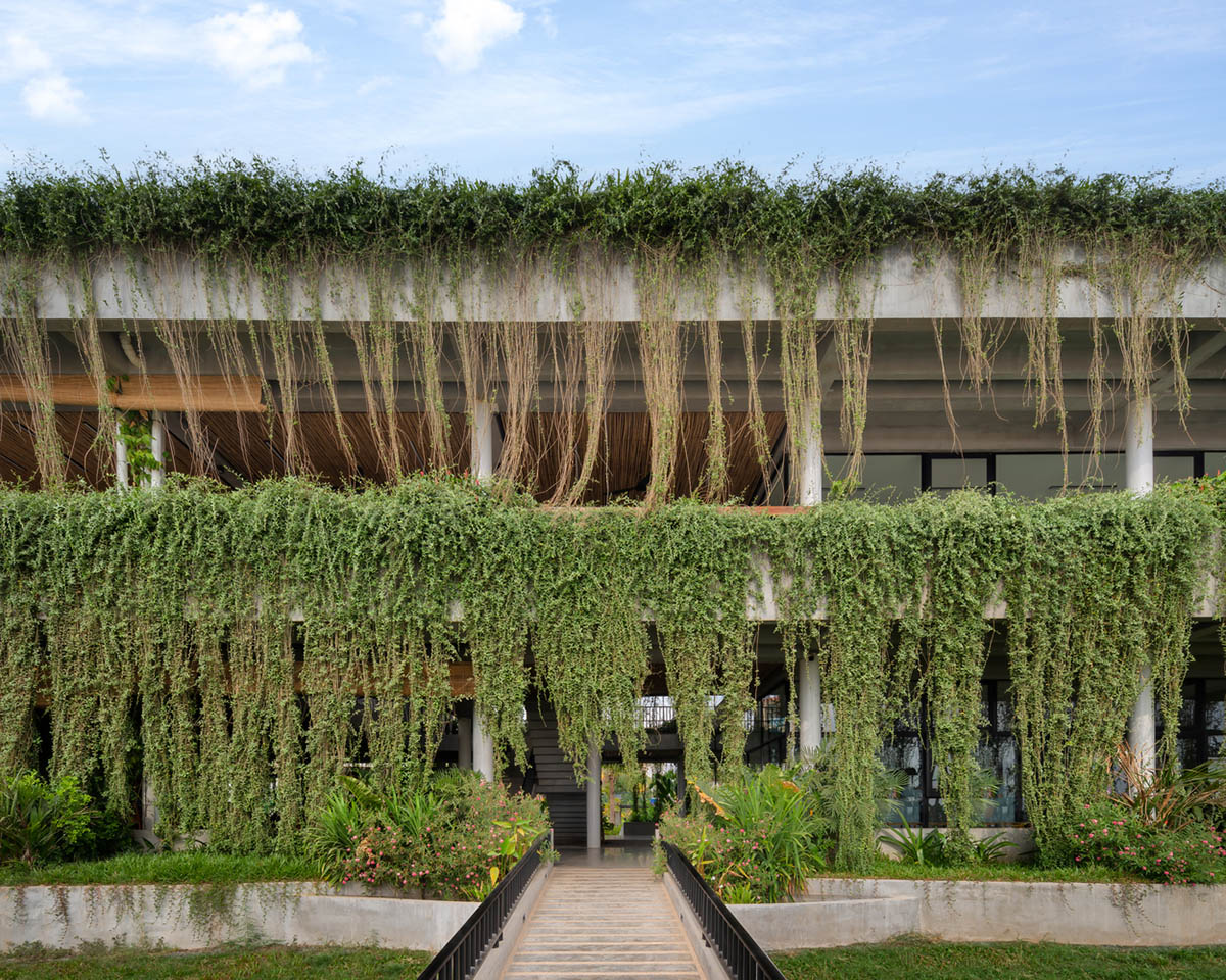 T3 Architects covers façade of Coconut Club in Cambodia with natural curtain made of plants 