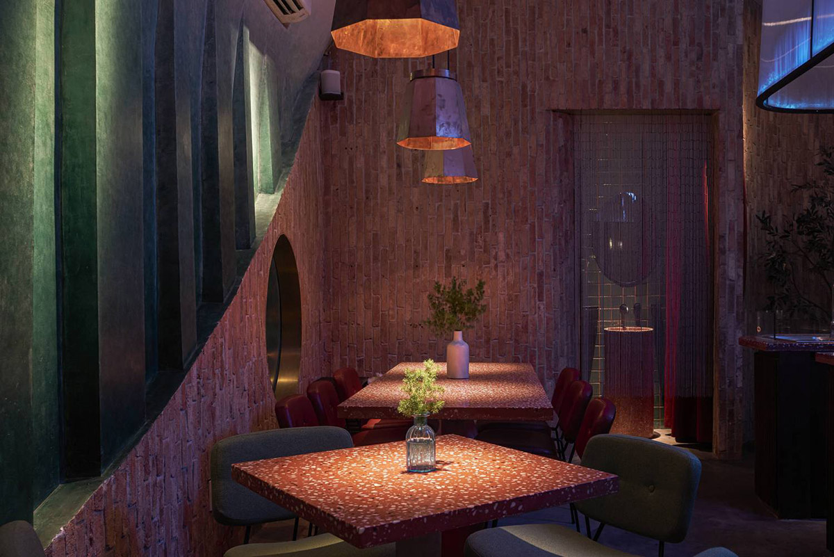 Red5studio built cafe evoking a retro spirit with hues of red colors and lights in Vietnam