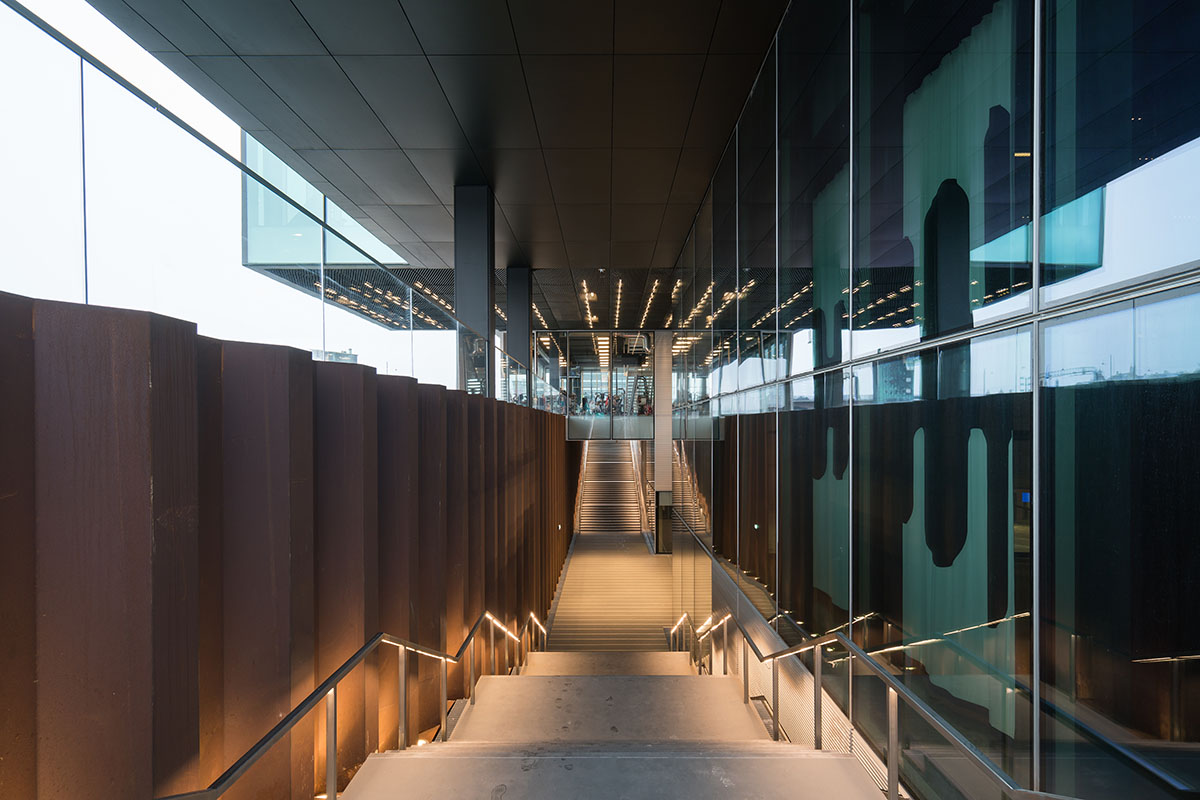 OMA's new cultural hub featuring a stack of green boxes opens in Copenhagen