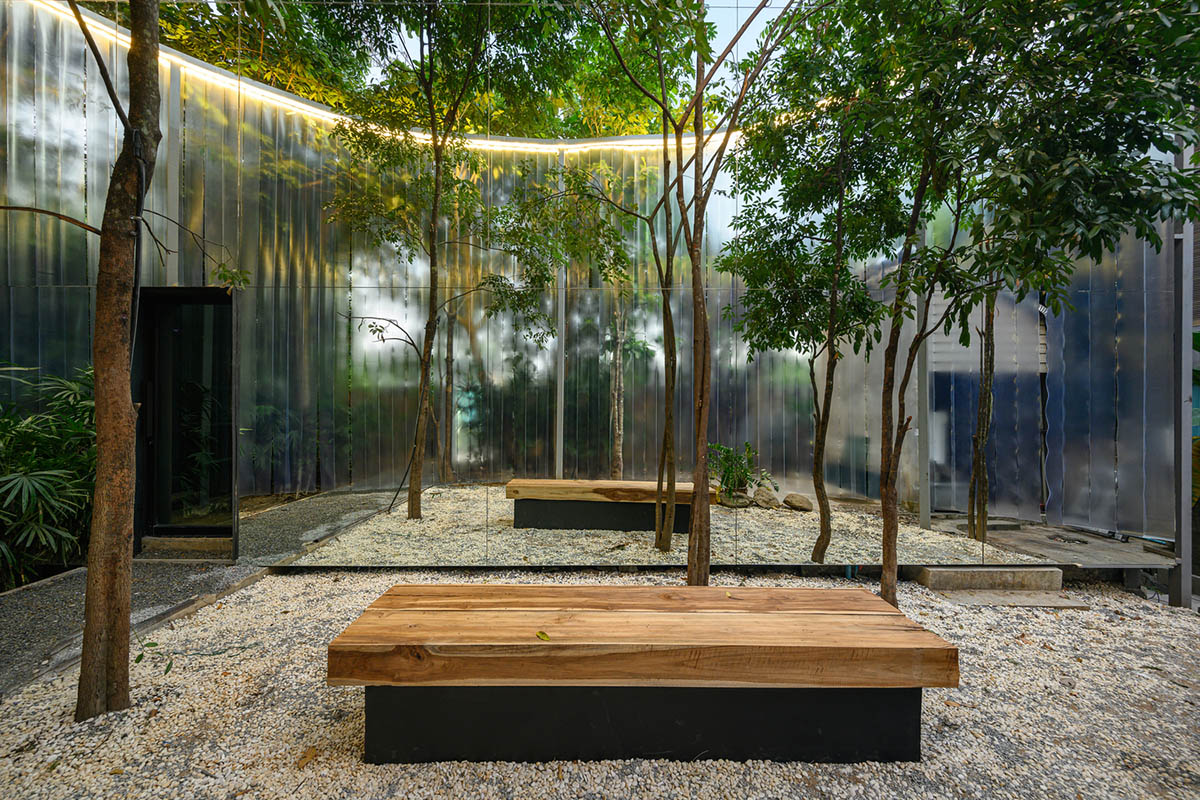 Sher Maker creates cafe from 6-meter opaque curtain wall in a forest in Thailand