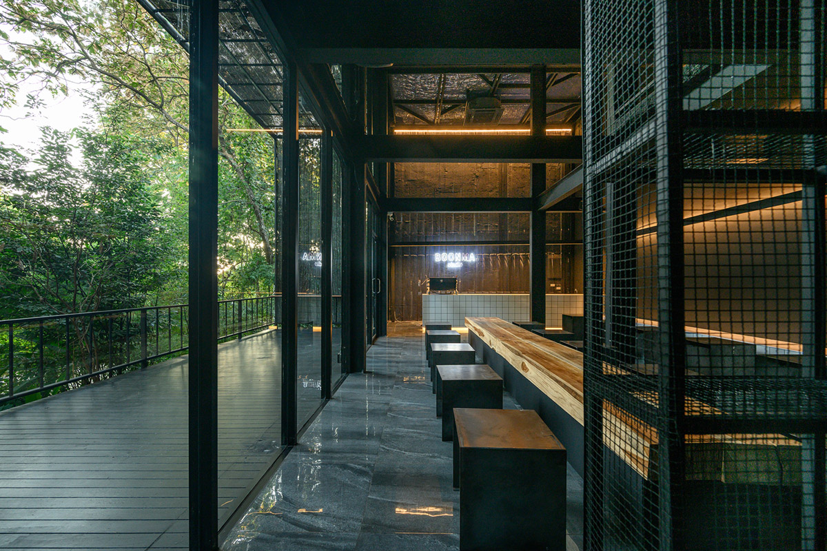 Sher Maker creates cafe from 6-meter opaque curtain wall in a forest in Thailand