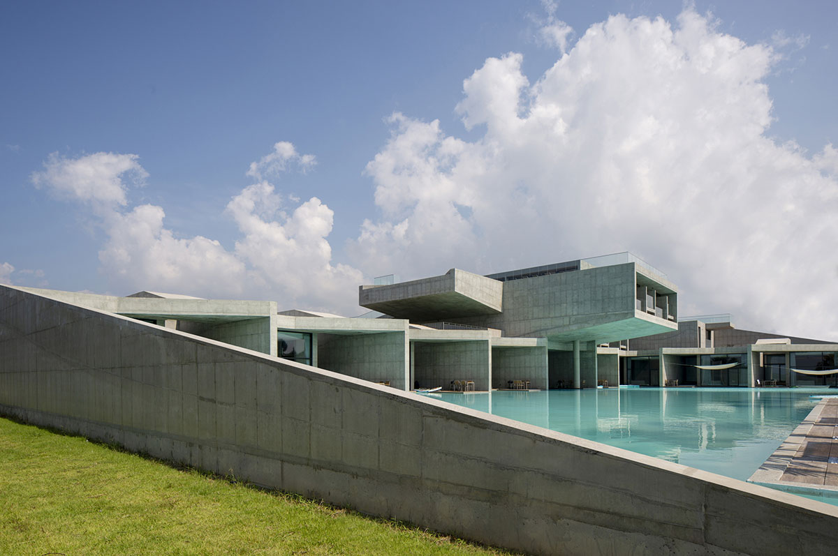 Elystay Resort is a striking horizontal concrete volume amidst scenic rural farmland in South Korea