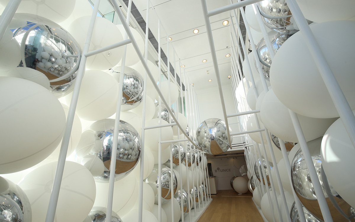 Snarkitecture fills giant steel cage with white bouncy balls at Harbour City of Hong Kong