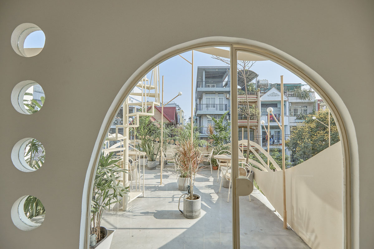 September Cafe is designed to look like a bird's nest with curved steel stripes in Vietnam