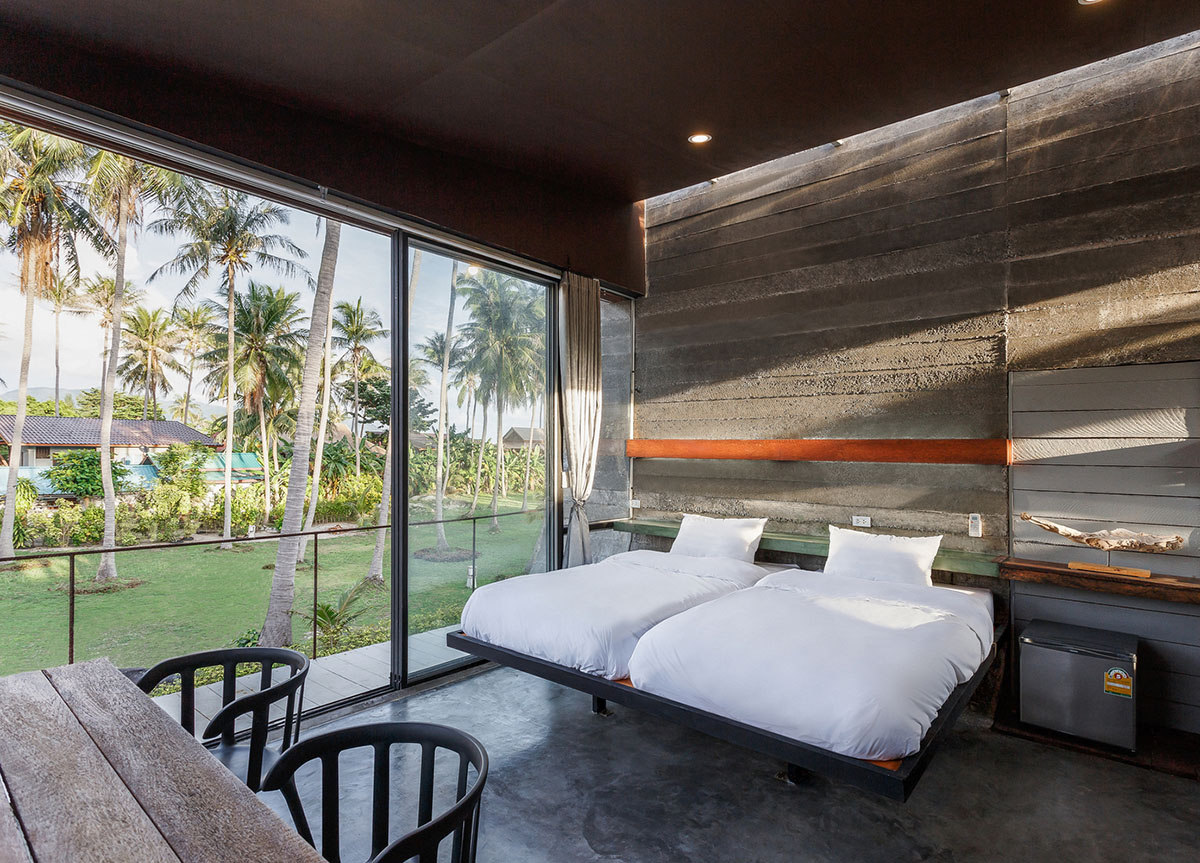 S-shaped concrete slabs form this Bunjob House by NPDA Studio at Phangan island in Thailand