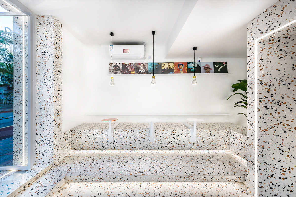 This tiny cafe by TOUCH Design is dotted with white and orange interwoven terrazzo details in Tianjin