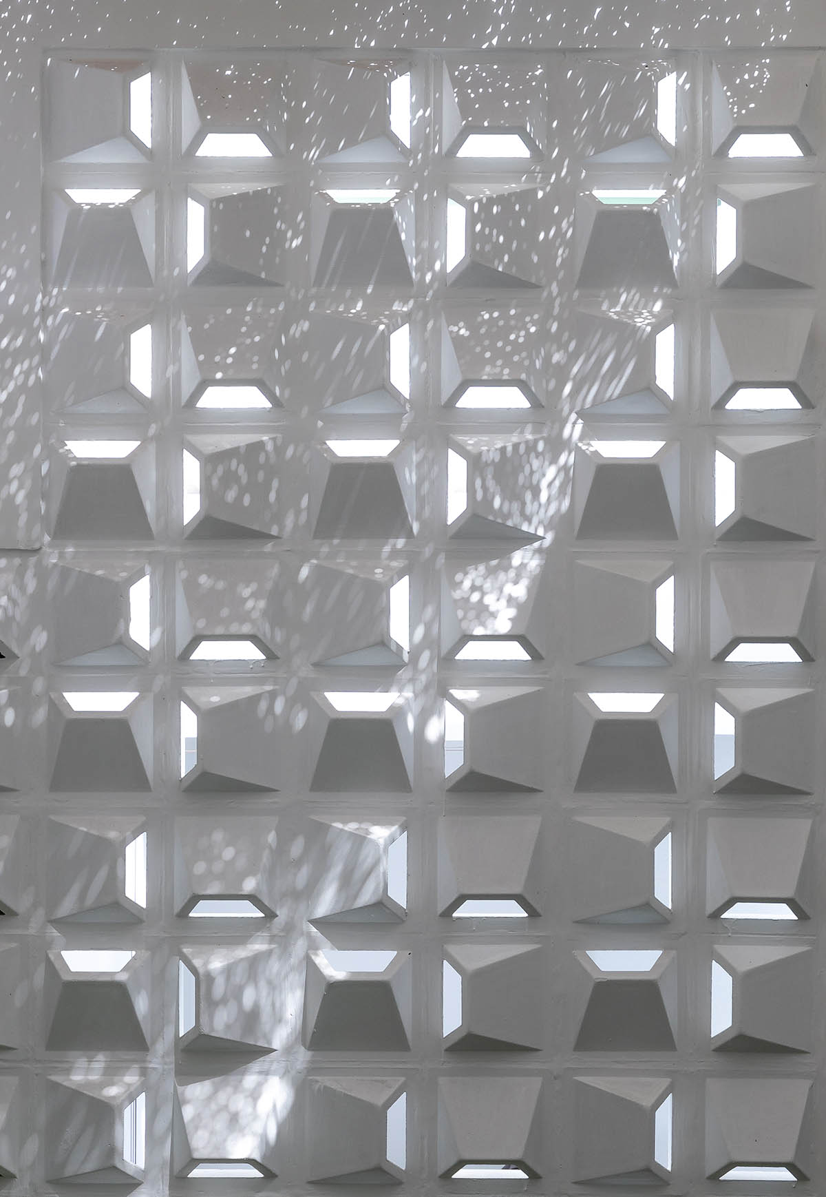 CoCo House, inspired by animated film, is clad in glass brick façade with wavy patterns in Vietnam