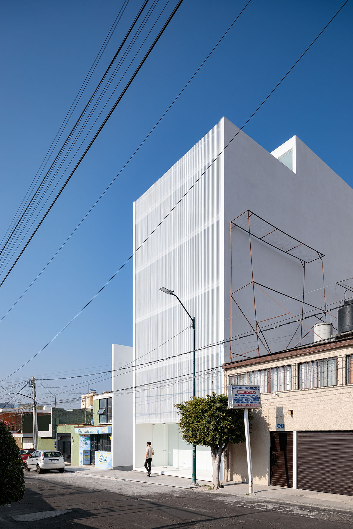 HW Studio adds lacework-looking façade to all-white house in Mexico