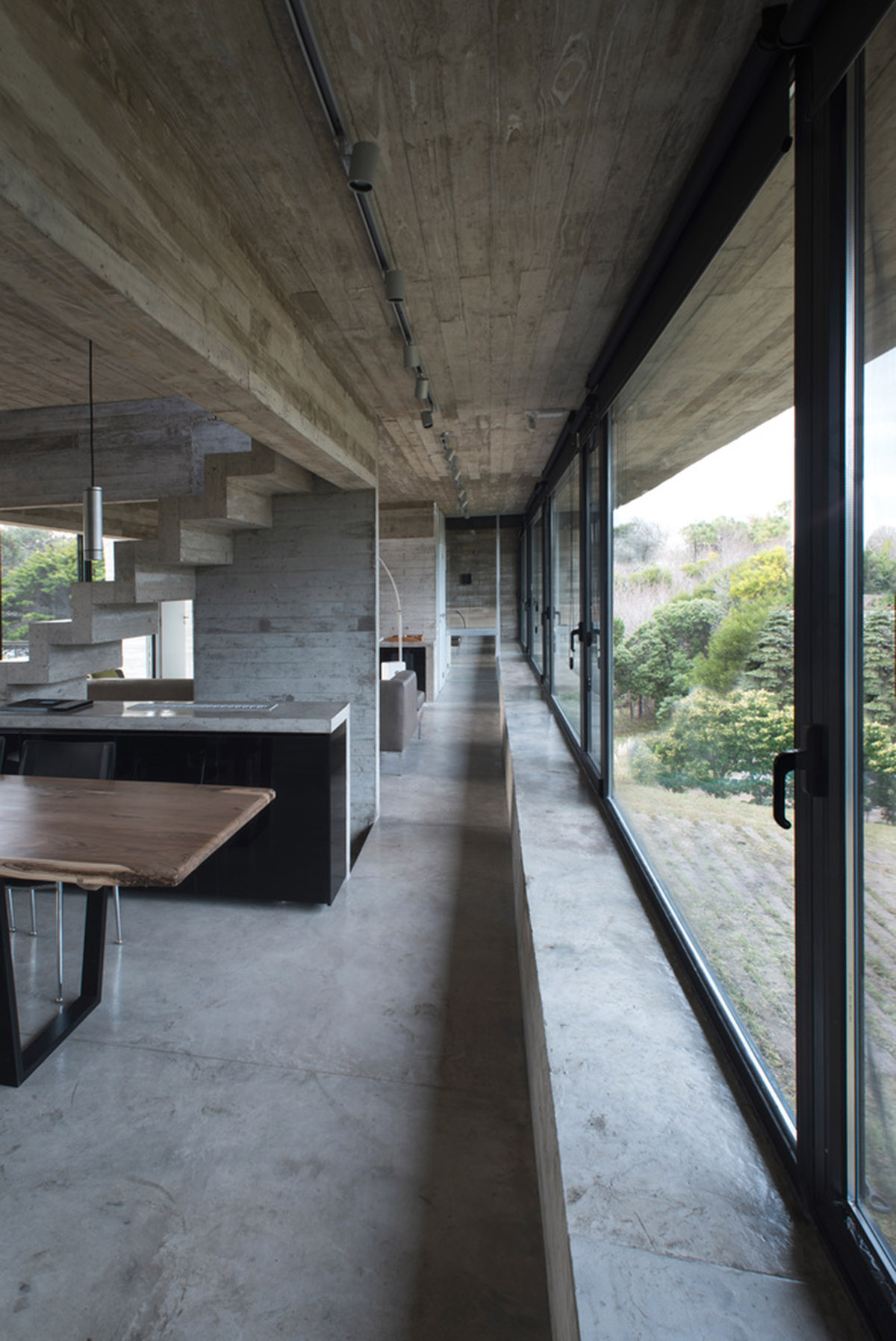 Luciano Kruk uses hanging volume for a vacation house supported by triangular column in Argentina