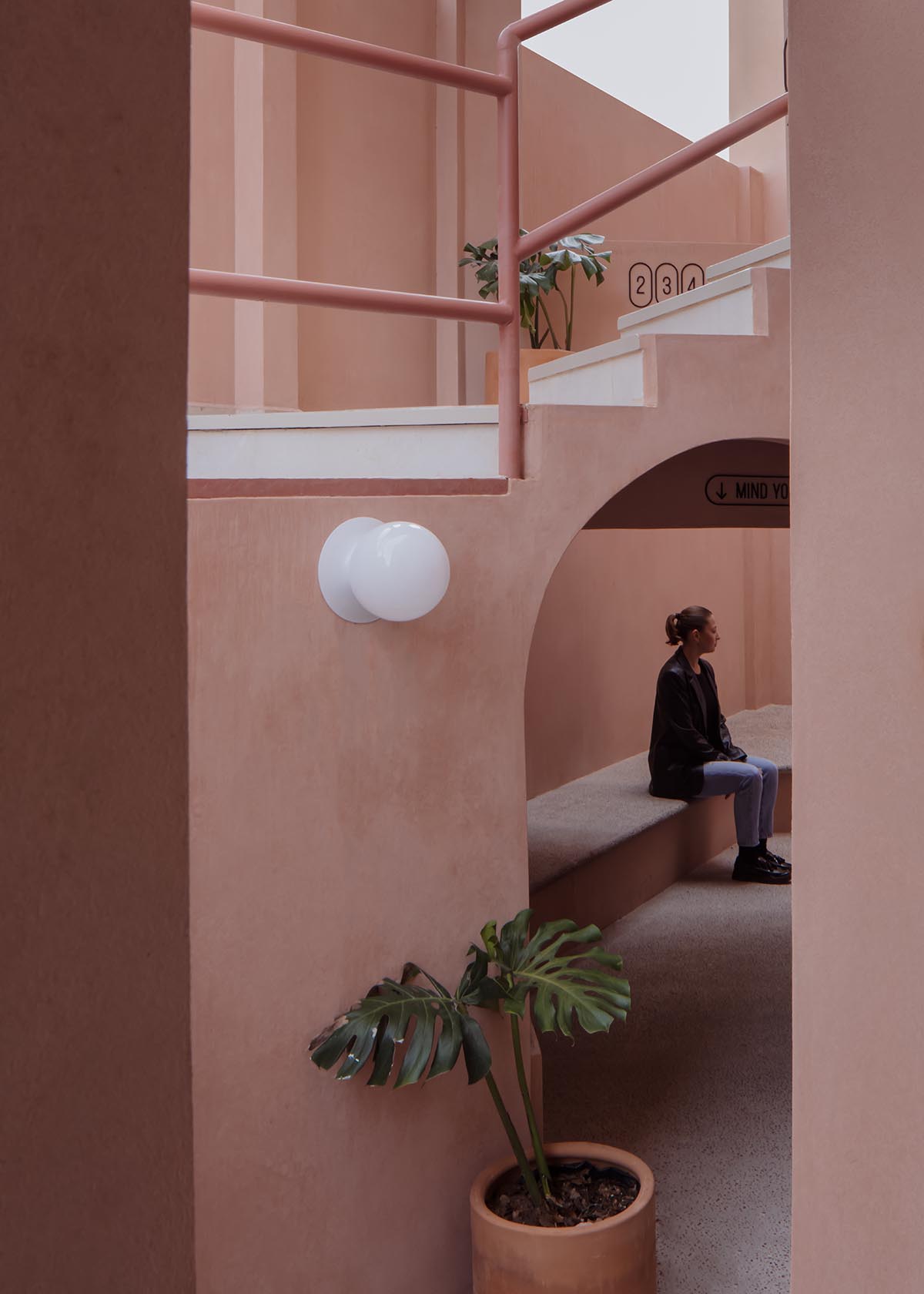 Heryco renovates Mexican apartment with layers of arches clad in pigmented lime stucco