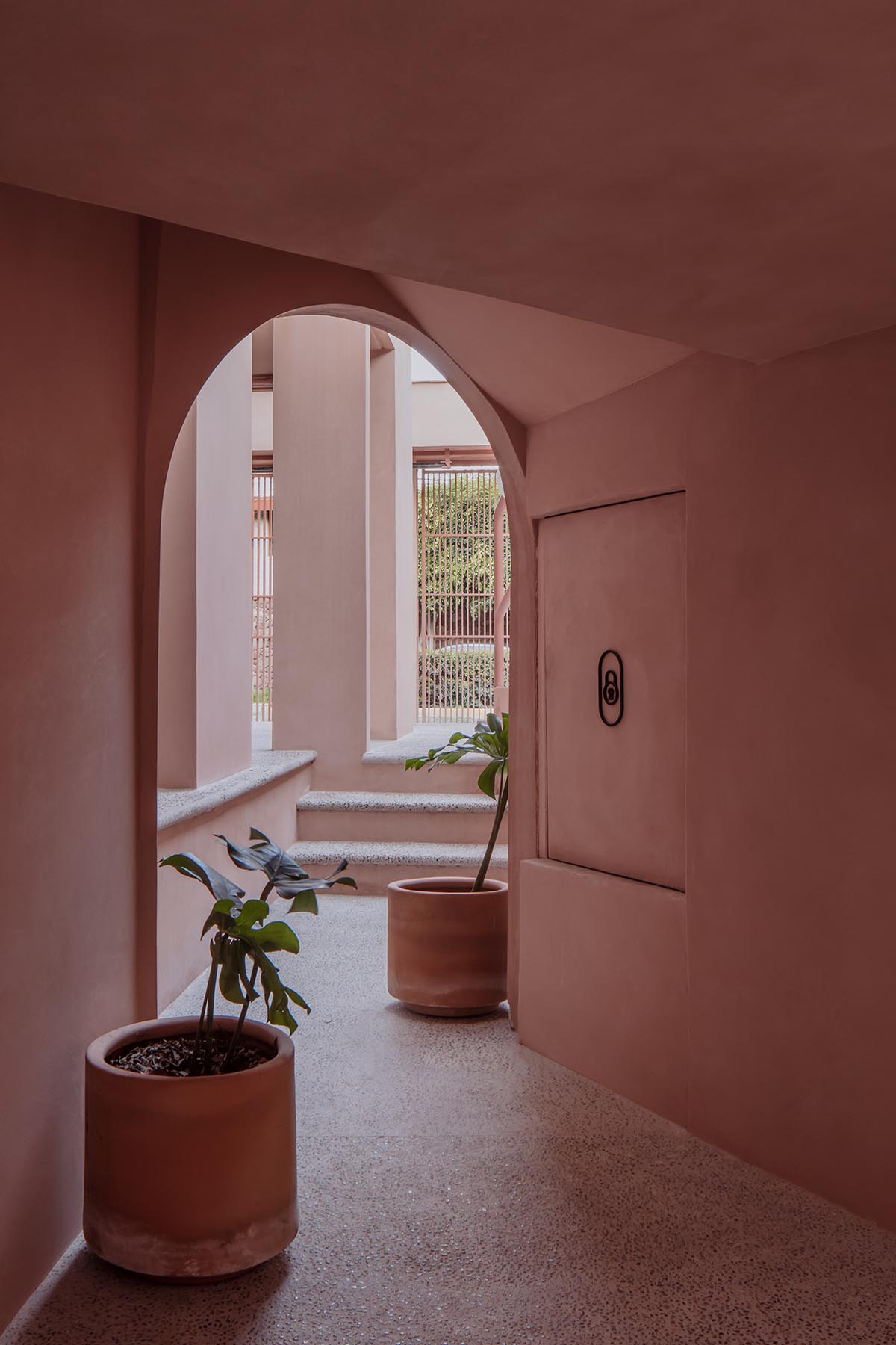 Heryco renovates Mexican apartment with layers of arches clad in pigmented lime stucco