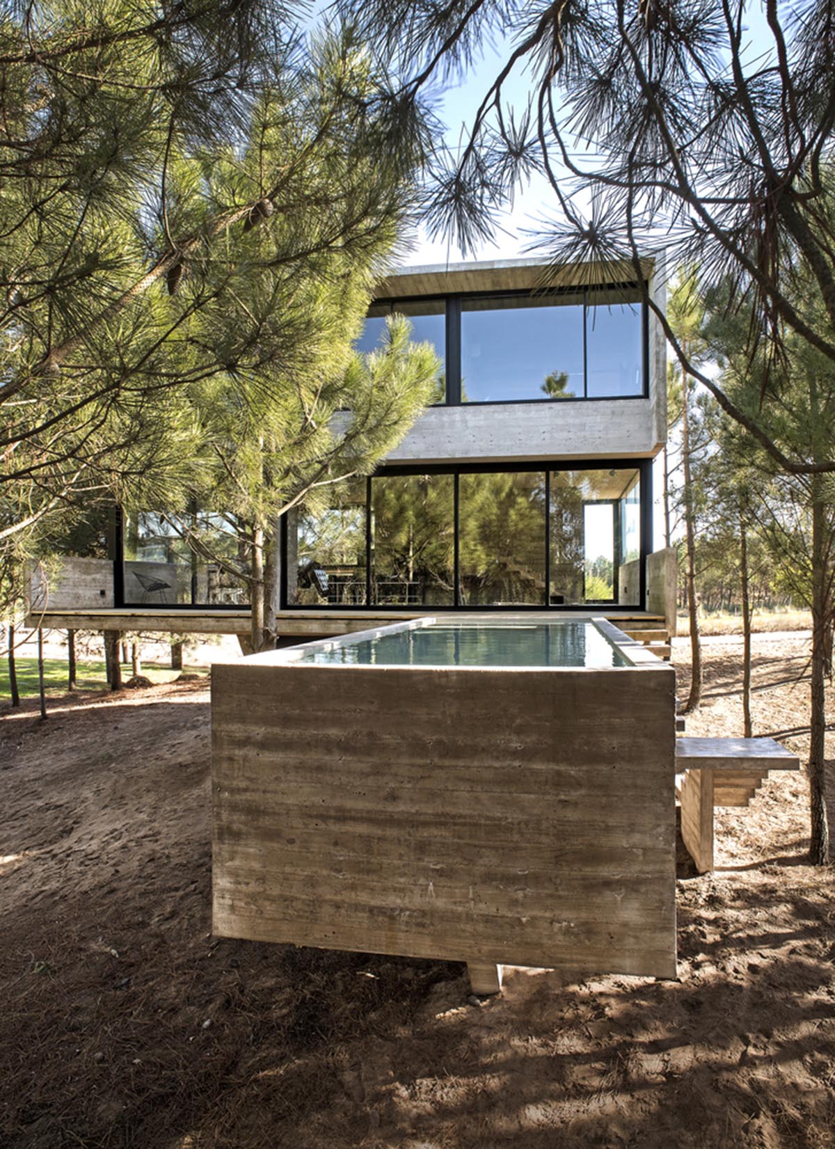 Luciano Kruk's concrete holiday home floats on a plinth and connects swimming pool with terrace
