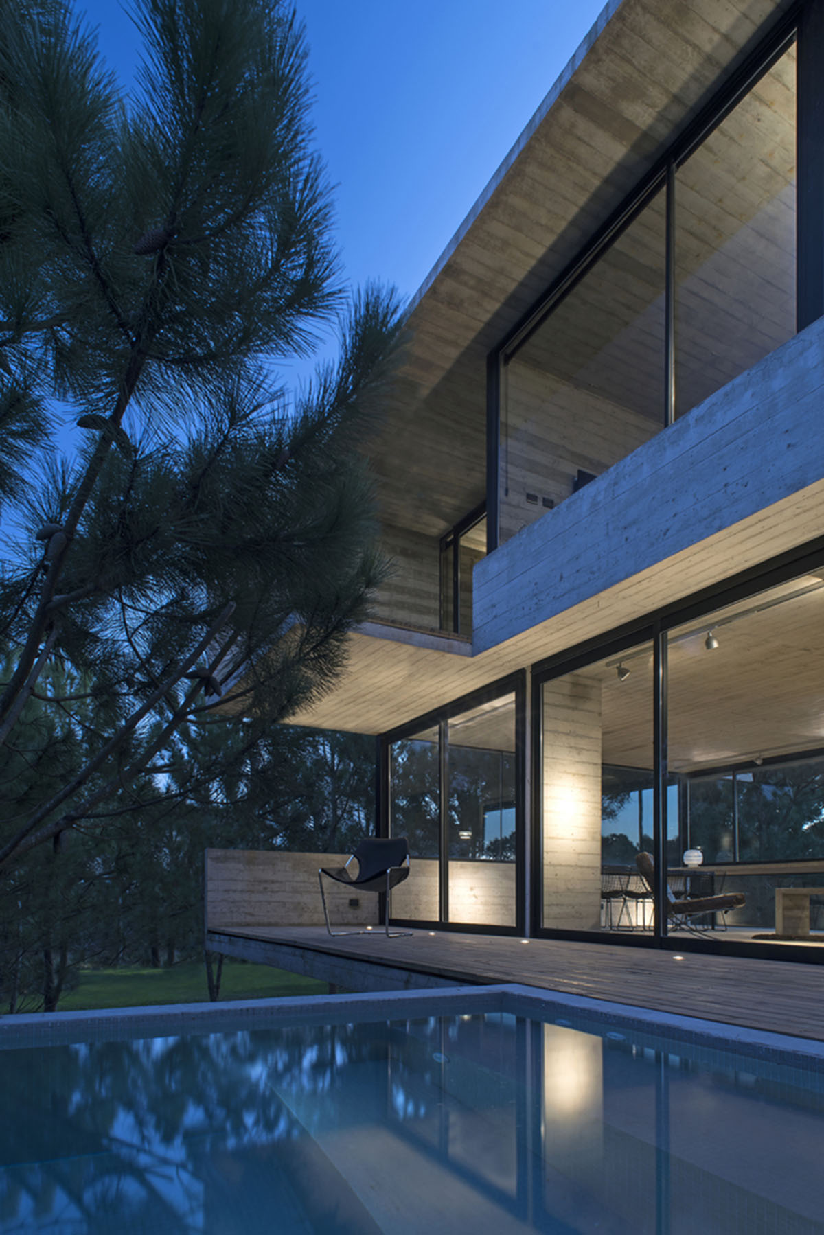 Luciano Kruk's concrete holiday home floats on a plinth and connects swimming pool with terrace