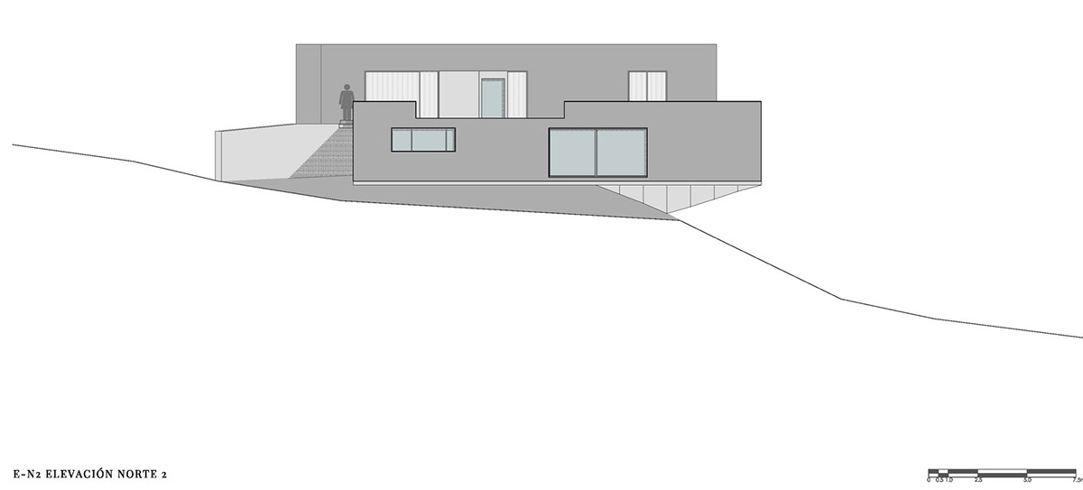 P+0 Arquitectura designs residence mixed with concrete and stone volumes on a complex terrain