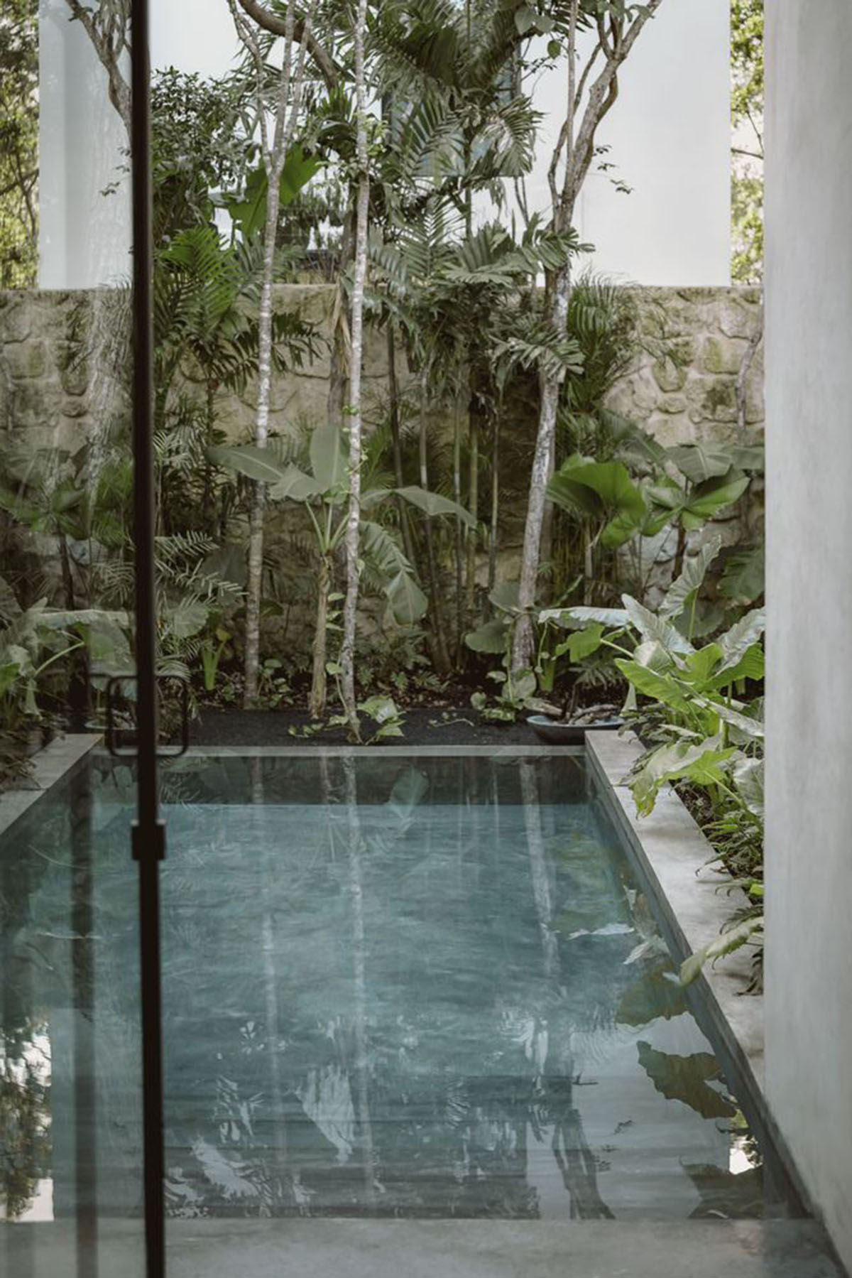 CO-LAB Design Office built concrete villa framing a lush jungle in Tulum