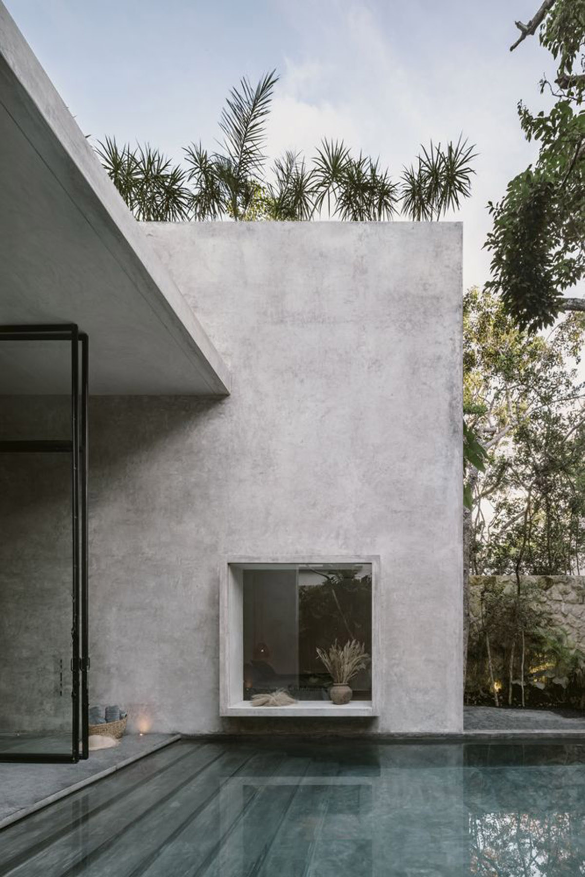CO-LAB Design Office built concrete villa framing a lush jungle in Tulum