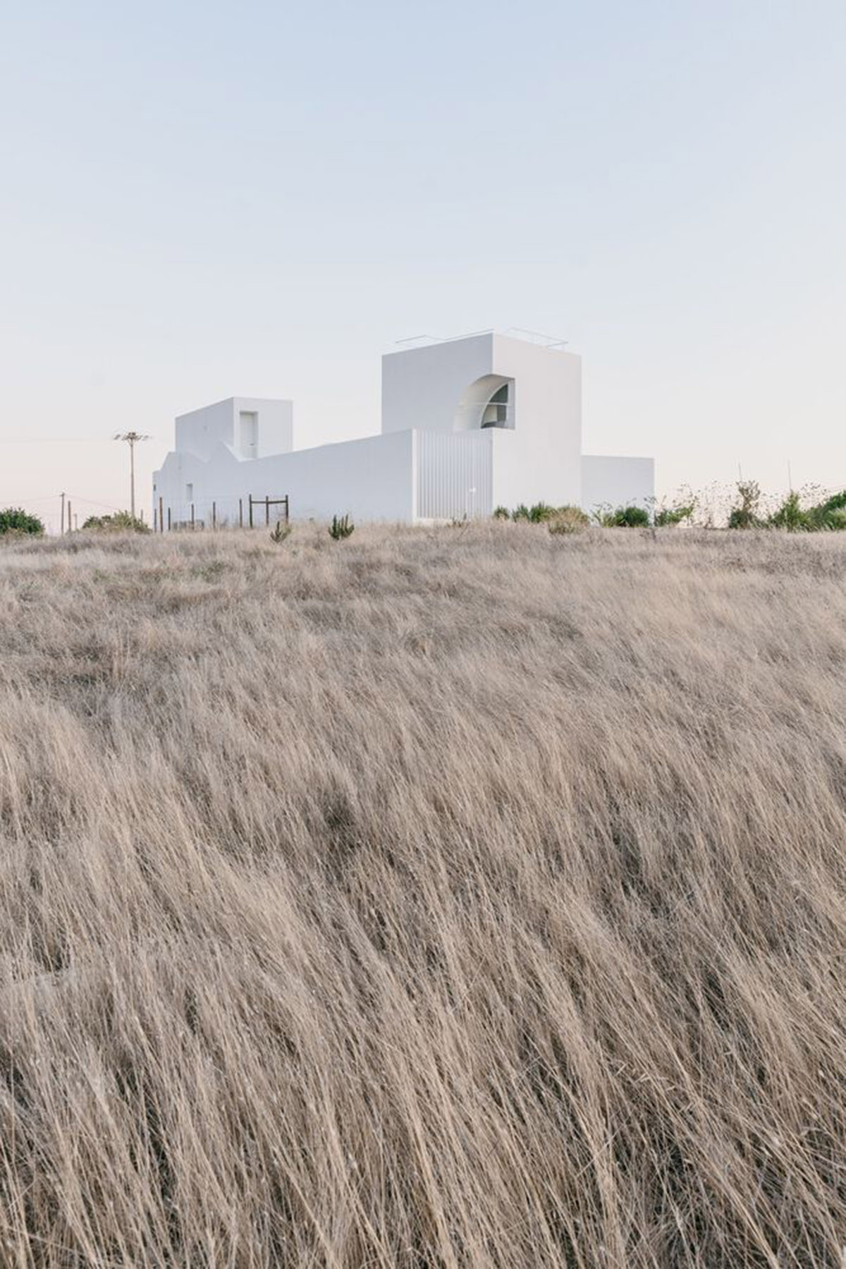 Portuguese holiday home is shaped around private patios and low-rise volumes in Algarve region