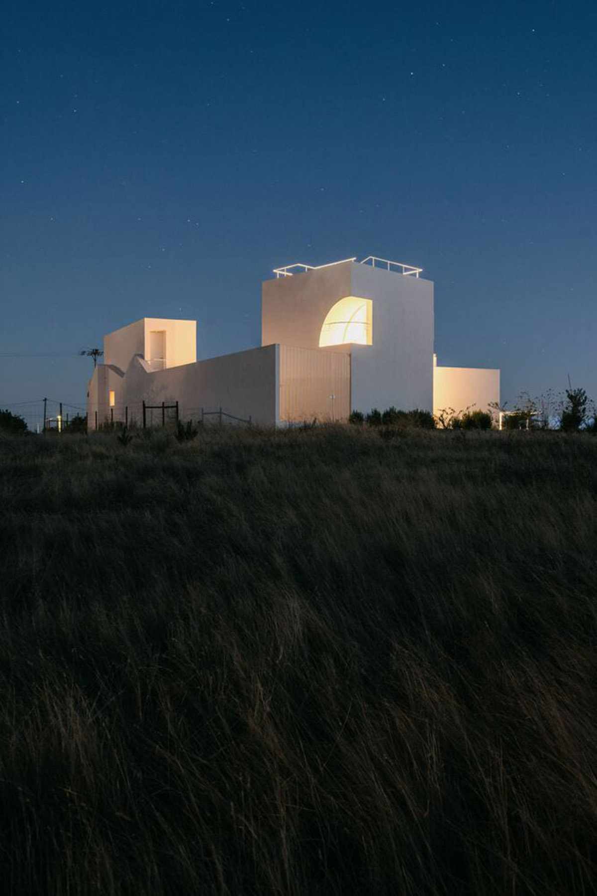 Portuguese holiday home is shaped around private patios and low-rise volumes in Algarve region
