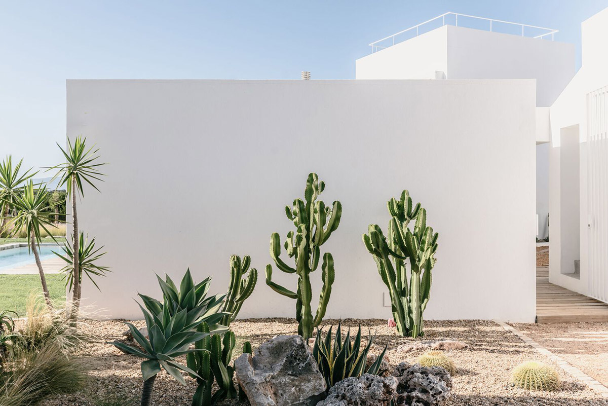 Portuguese holiday home is shaped around private patios and low-rise volumes in Algarve region
