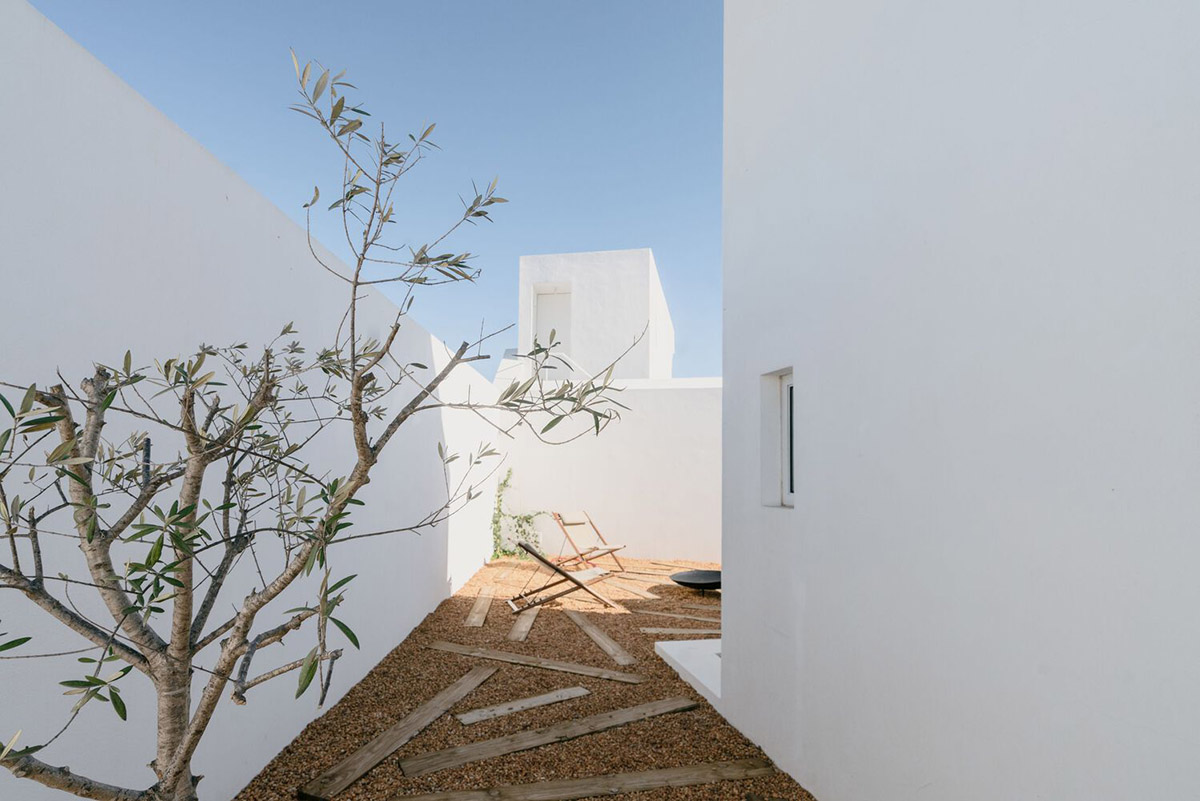 Portuguese holiday home is shaped around private patios and low-rise volumes in Algarve region