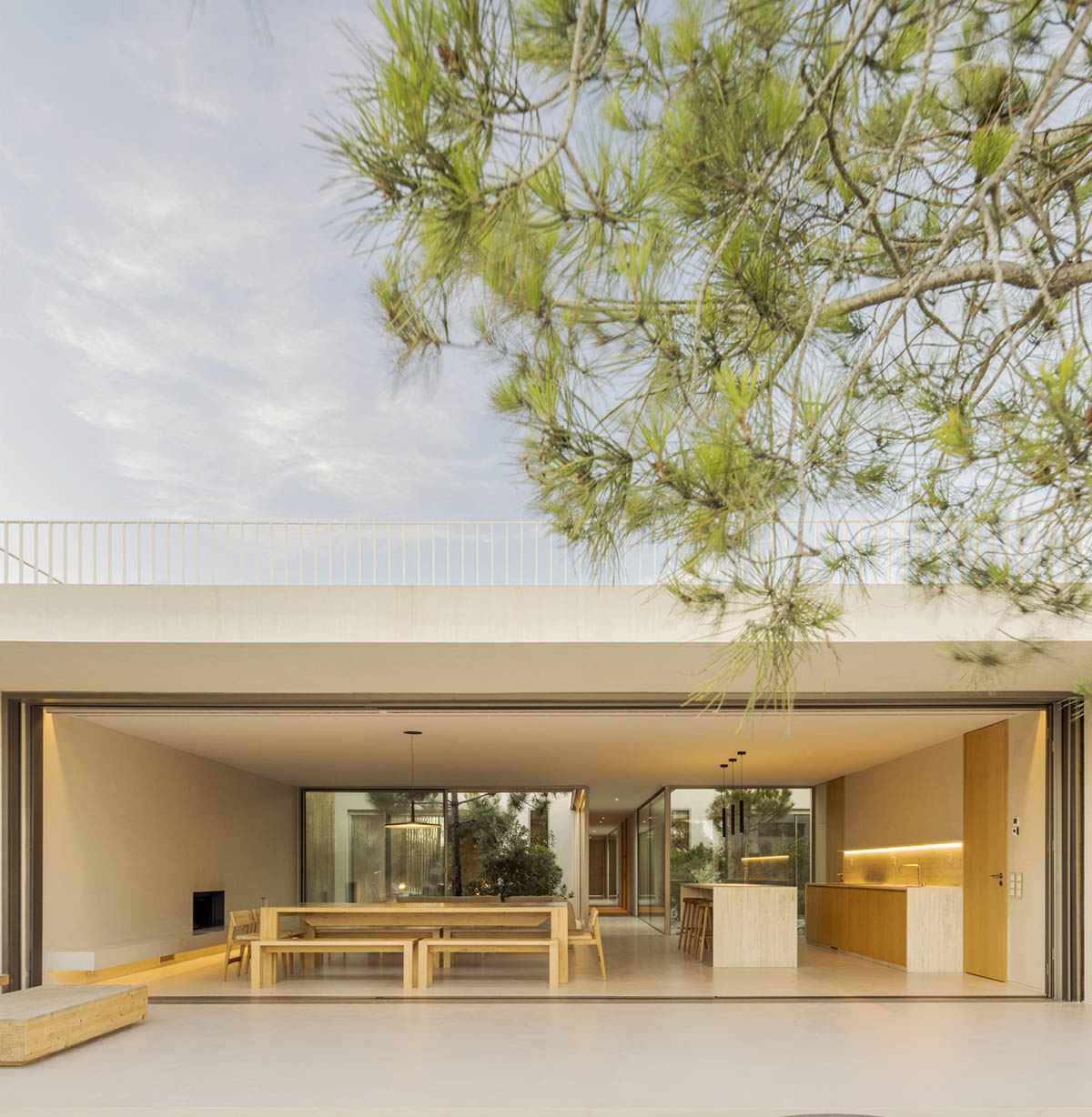 Palisade House is wrapped by a long palisade in fir wood to protect dunes in Troia, Portugal 