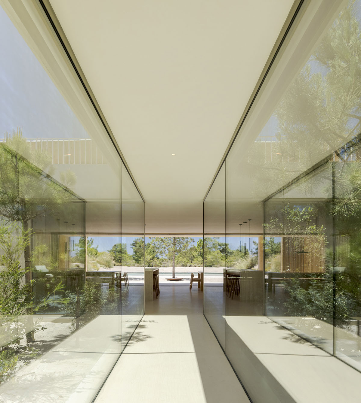 Palisade House is wrapped by a long palisade in fir wood to protect dunes in Troia, Portugal 