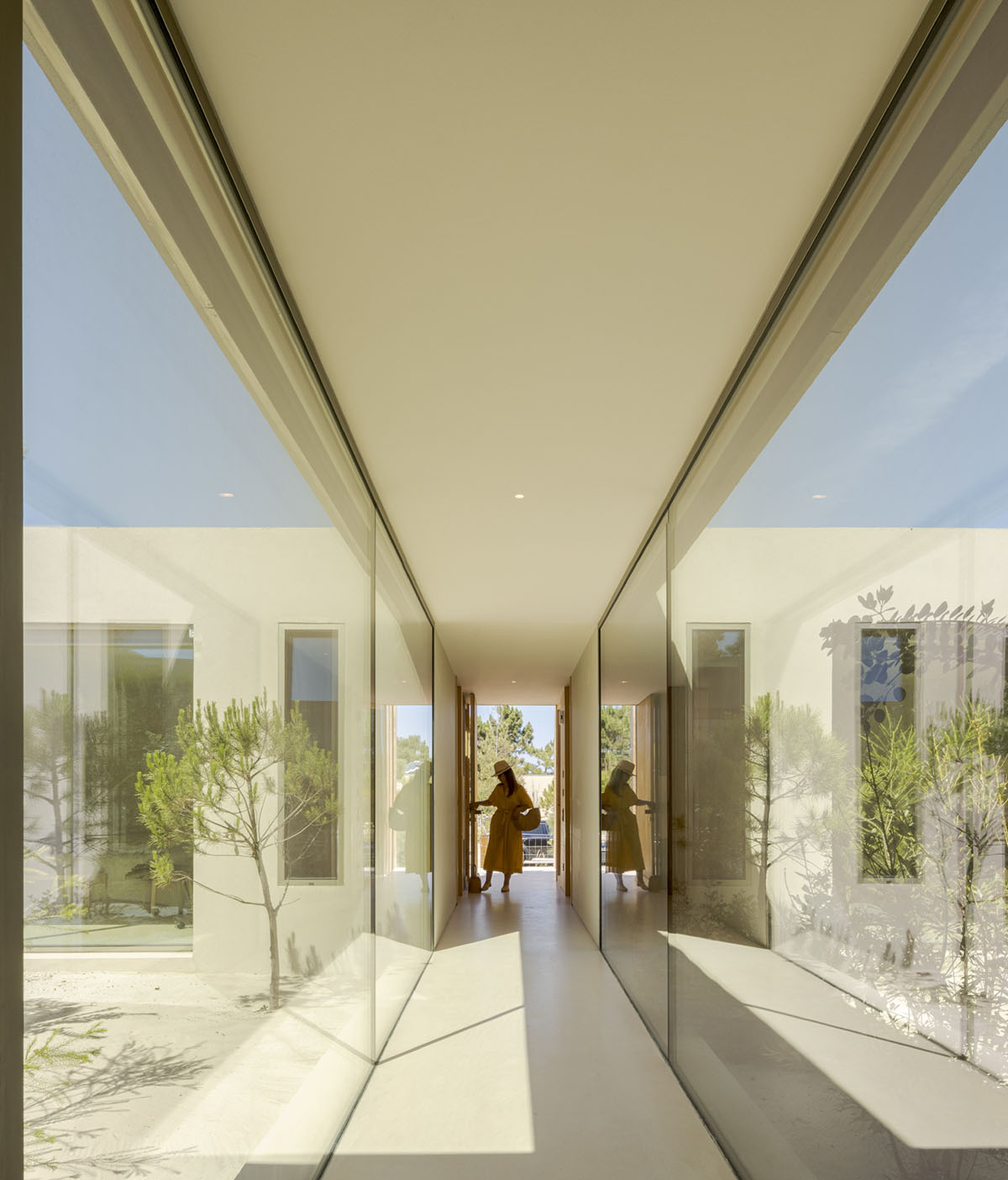 Palisade House is wrapped by a long palisade in fir wood to protect dunes in Troia, Portugal 