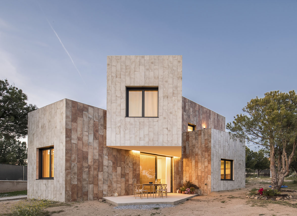 OOIIO Architecture plays with intersection of red ceramic-tiled volumes to create house in Madrid