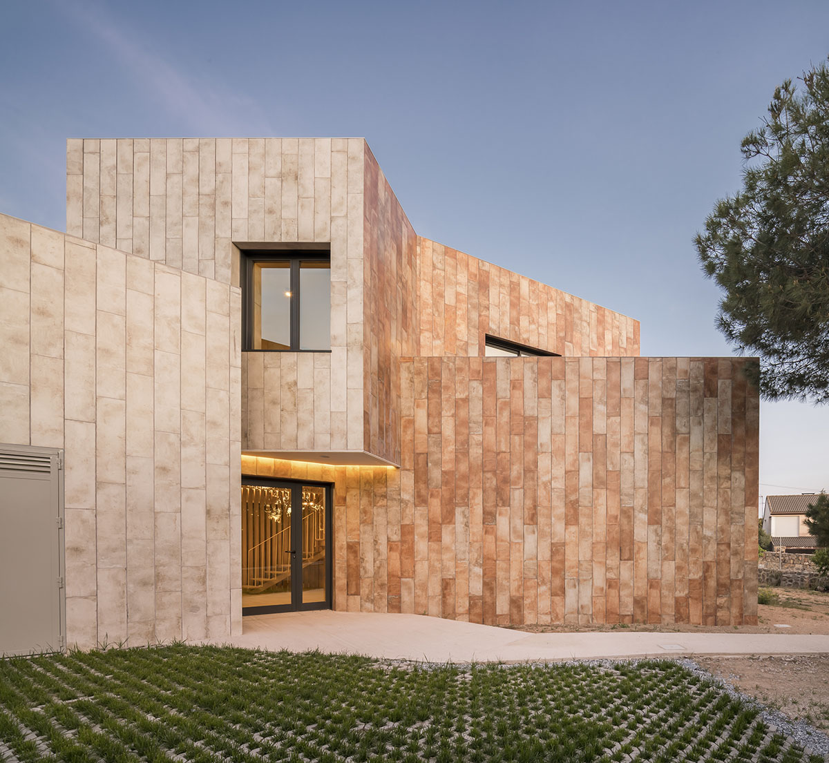 OOIIO Architecture plays with intersection of red ceramic-tiled volumes to create house in Madrid
